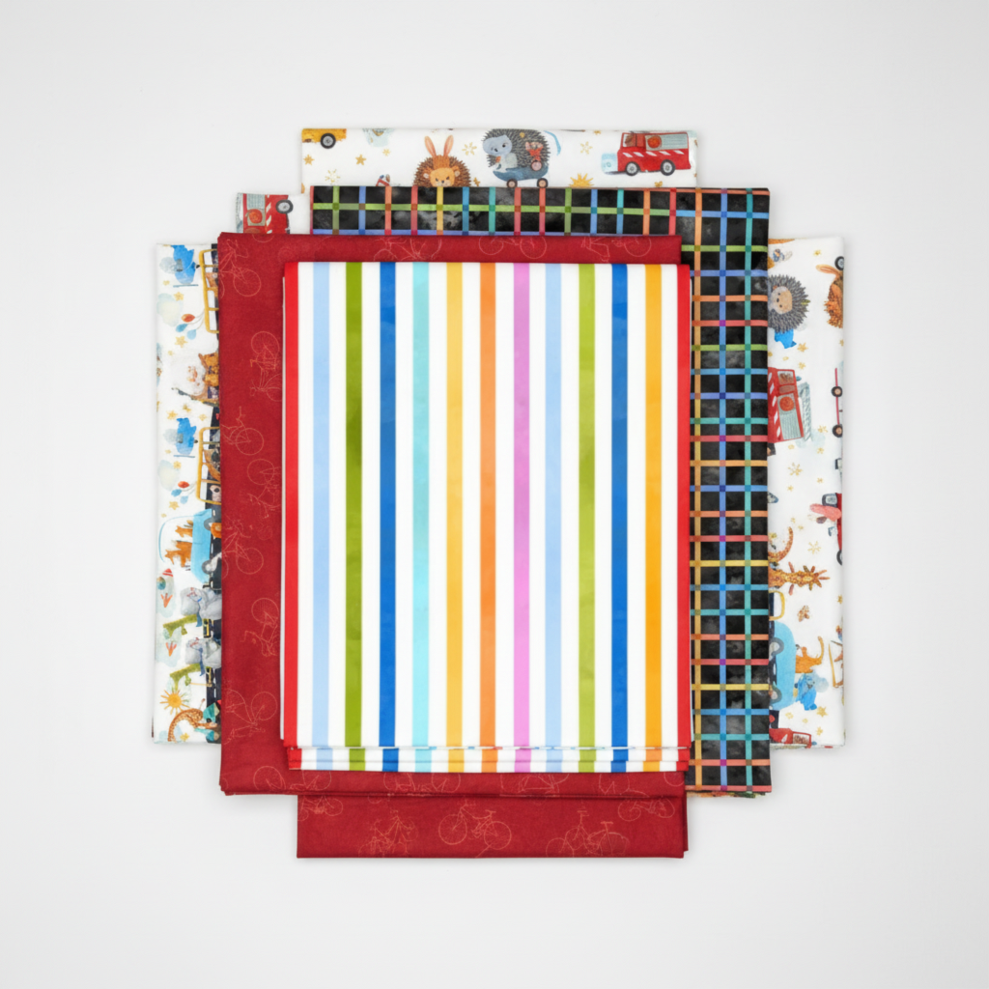 On the Go Stripes Multi quilting cotton by Jason Yenter for In The Beginning Fabrics — shown in a coordinating fabric fold stack with the rainbow stripe as the clear hero, on a clean white surface with bright studio lighting.
