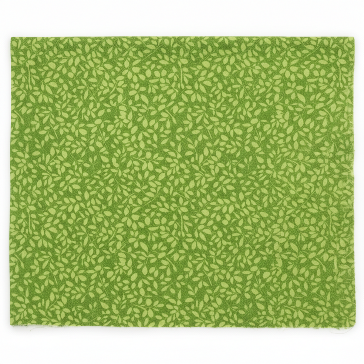 On the Go Leaves Green quilting cotton by Jason Yenter for In The Beginning Fabrics — flat lay showing dense all-over tone-on-tone print of small elongated oval leaves in soft chartreuse-green on a lush grass-green ground, raw cut edges visible, 100% cotton, 43–44" wide.