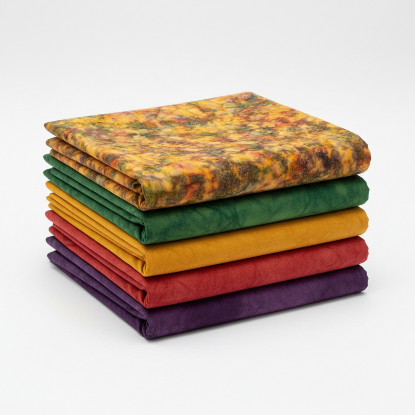 Expressions Batiks Hand-Dyes Orange Multi I fabric by Riley Blake Designs on top of a coordinating stack of five Expressions Batiks Hand-Dyes tonal batik fabrics – complex multicolor amber-orange on top with forest green, curry yellow, tomato red, and deep purple tonal batiks below, 100% cotton