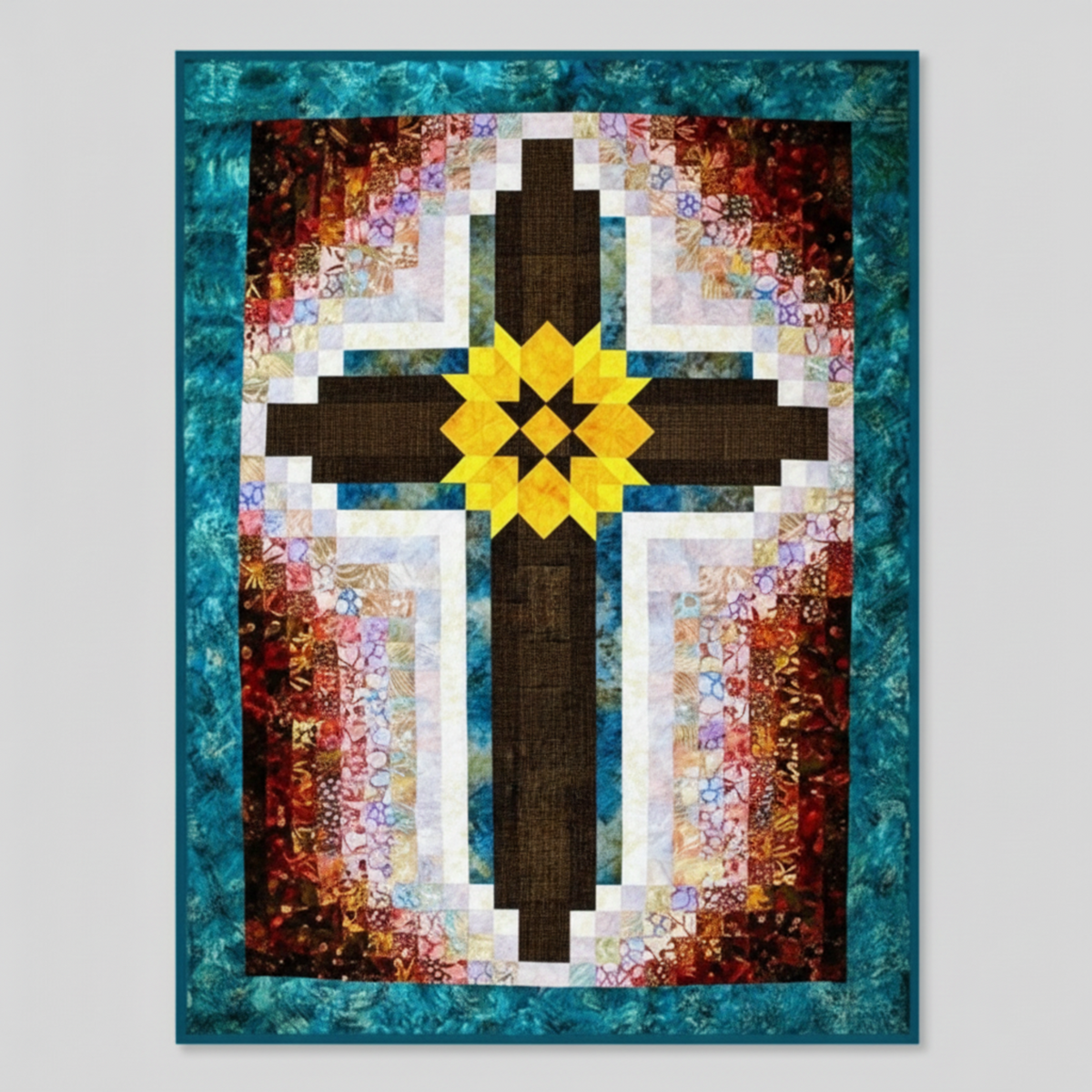 Painted Cross quilt made with Interwoven Bark Fabric by Jason Yenter for In The Beginning Fabrics – dark brown crosshatch cross arms with yellow eight-pointed star medallion, warm multicolor batik strips, white sashing, and teal border