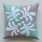 Pastel Harmony mint-and-mauve quilted pillow with raised white teardrop motifs, textured echo quilting, and pale mint edging on light grey.
