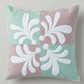 Pastel Harmony quilted pillow with four alternating mint-green and dusty-mauve squares, raised white teardrop motifs, and echo quilting on light grey.