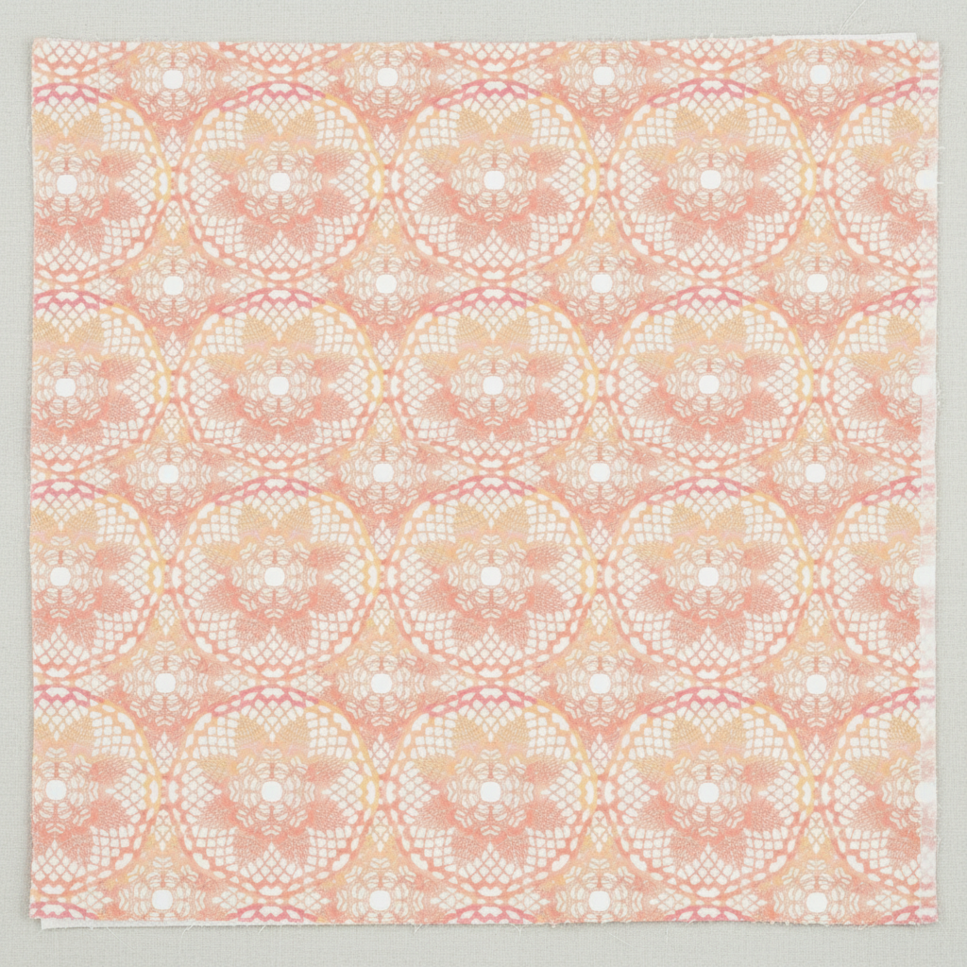 Patricia Coral Lace close-up flat layPatricia Coral Lace 3-Yard Cut quilting cotton by Jason Yenter for In The Beginning Fabrics — close-up flat lay showing overlapping circular lace medallions with intricate lattice diamonds, filigree arcs, and delicate floral centers in soft blush coral, warm peach, and creamy white with rose-pink accents, 100% cotton, 43–44" wide.
