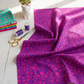 PAWsitivity Purple Field quilting cotton by Jason Yenter for In The Beginning Fabrics — loosely draped on a white wooden floor with a stack of coordinating PAWsitivity collection fabrics, purple thread spools, gold scissors, and a cat-shaped succulent planter in a bright natural-light sewing room. Coordinating fabrics and quilt patterns are available at IraRobi Quilts.