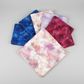 Fire & Ice by Maywood Studio cotton quilting fabric collection fanned overhead on light grey surface with Peach Ice Dye as the focal colorway