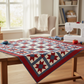 Interwoven Red Fabric by Jason Yenter for In The Beginning Fabrics featured as star points and border in a Pick A Star quilt top in progress on a sewing table — vivid true red crosshatch tonal with scarlet-to-deep-warm-red tonal shifts, paired with slate blue sashing on a cream background. Quilts shown for inspiration feature the Pick A Star Quilt Pattern by Bound to Be Quilting — available at IraRobi Quilts.
