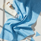 Safari Fun Floating Triangles Blue quilting fabric by Terry Runyan for Benartex – draped with coordinating sewing notions and cut triangle quilt pieces, light grey background