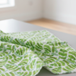 Safari Fun Jungle Leaves White quilting cotton softly draped in a bright airy studio — fresh watercolor banana leaves and fern sprigs on white by Terry Runyan for Benartex | IraRobi Quilts