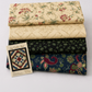 Vintage Charm by Judie Rothermel for Marcus Fabrics – 4-fabric reproduction quilt coordination stack featuring cream floral vine, cream lattice, black green ditsy floral, and navy paisley cottons with Log Cabin Star quilt pattern by Nancy Rink