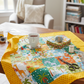 Safari Fun quilt in progress on a wooden table with yellow polka dot border fabric, tea mug, scissors, and thread in a cozy quilting workspace — IraRobi Quilts