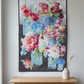 Vase with Flowers floral wall quilt hanging above an oak console beside a window, with a cream vase holding dried stems.