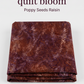 Folded Poppy Seeds Raisin Fabric by Riley Blake Designs on a light-gray background. Text reads: ‘Let your next quilt bloom,’ ‘Poppy Seeds Raisin,’ ‘by Riley Blake Designs,’ and ‘Find inspiration at IraRobi Quilts.