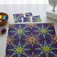 What If Radio Star Purple/Multi quilting fabric in progress with cut star block pieces, sewing machine, and thread basket — Paula Nadelstern for Benartex kaleidoscope quilt project