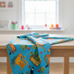 Safari Fun Playful Safari Blue quilting cotton softly draped on a wooden table in a bright children's room — bold novelty jungle animal print by Terry Runyan for Benartex | IraRobi Quilts