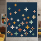 Spotted Mood Dark Blue fabric by Zen Chic for Moda Fabrics shown as the background in a modern plus-block quilt with coordinating warm-toned fabrics — available at IraRobi Quilts.