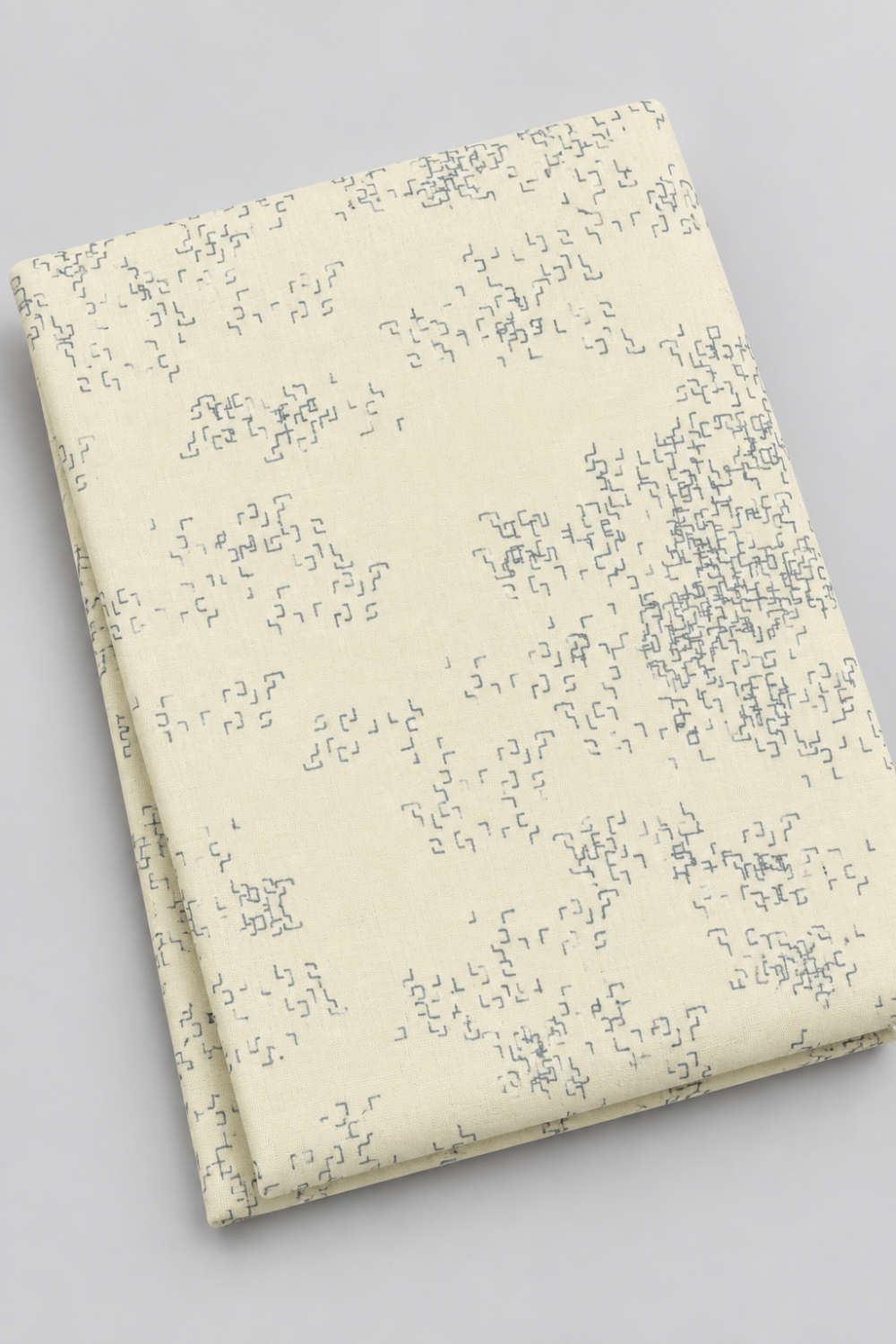 Folded Modern Background Even More Paper Eggshell Edgy fabric by Zen Chic for Moda Fabrics on a light gray background, showing scattered gray angular marks on eggshell.