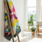 Posh Blossom quilt pattern by Sew Kind of Wonderful made with Expressions Batiks Hand-Dyes Charcoal as background fabric and jewel-tone hand-dyed batiks by Riley Blake Designs – Posh Blossom pattern available at IraRobi Quilts