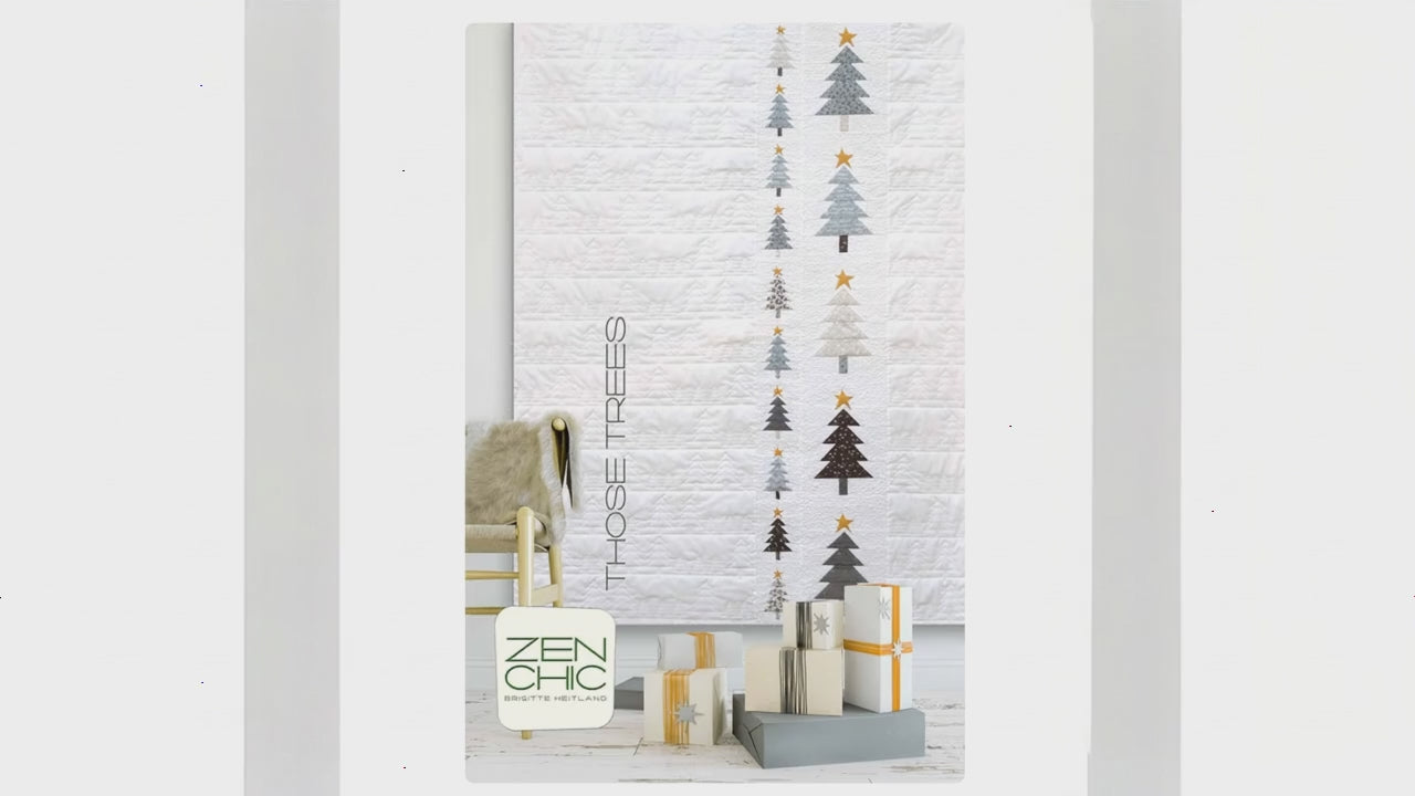 Decorative wall art with Christmas tree designs and presents on a white brick wall.