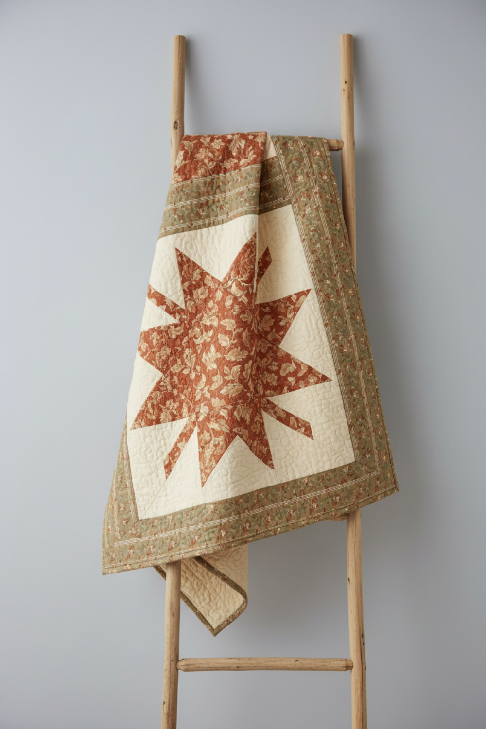 Traditional Ohio Star quilt featuring Front Porch quilting cottons by Dolores Smith for Marcus Fabrics — rust-amber, taupe, and olive-gold with cream background, 100% cotton 43–44" wide — shop at IraRobi Quilts