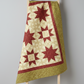 Traditional star quilt featuring Golden Era coordinating quilting cottons by Paula Barnes for Marcus Fabrics — cream, crimson-red, and sage-olive green colorways, 100% cotton 43–44" wide — shop at IraRobi Quilts