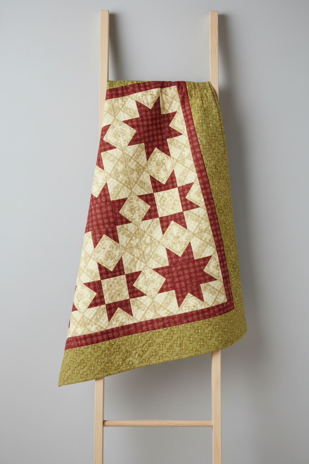 Traditional star quilt featuring Golden Era coordinating quilting cottons by Paula Barnes for Marcus Fabrics — cream, crimson-red, and sage-olive green colorways, 100% cotton 43–44" wide — shop at IraRobi Quilts