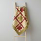Traditional Ohio Star quilt made with Golden Era coordinating fabrics by Paula Barnes for Marcus Fabrics — cream diagonal lattice, crimson-red honeycomb check, and sage-olive wavy daisy quilting cottons, 100% cotton