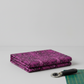 Needle Stars Chandelier Fuchsia quilting fabric with rotary cutter and cutting mat — bold marbled feather swirl print by Paula Nadelstern for Benartex