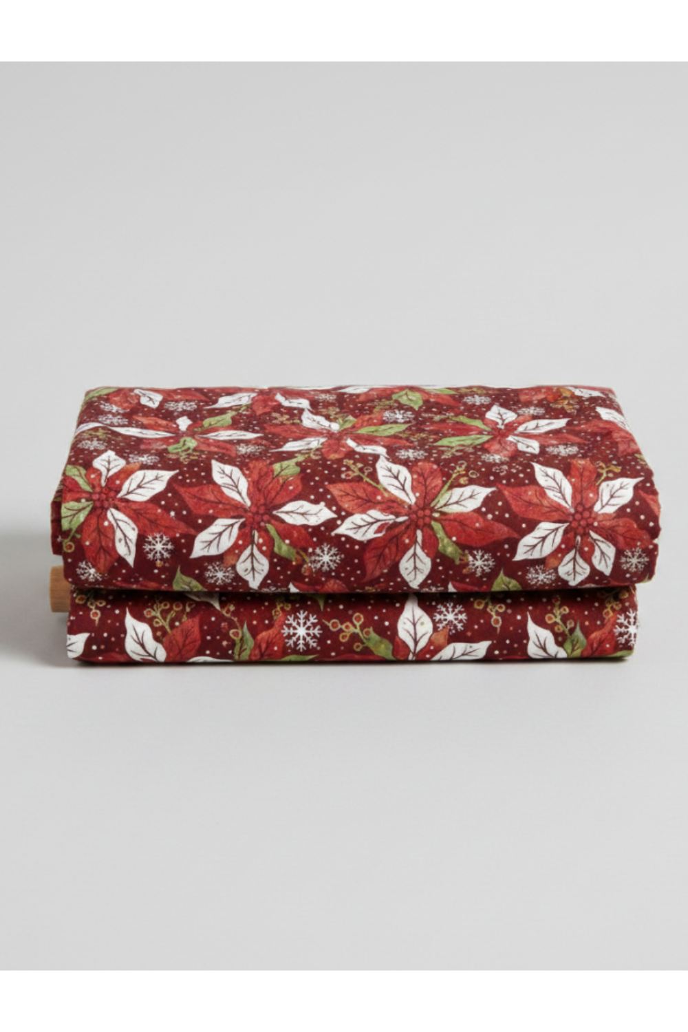 Winter Solstice II Red Poinsettia Metallic quilting cotton by Jason Yenter for In The Beginning Fabrics — folded fabric bolt showing kaleidoscopic poinsettia pinwheels in deep red, white, and forest green on rich burgundy with scattered white snowflakes and gold metallic berry sprigs, 100% cotton with metallic accents, 43–44" wide. Quilt blocks shown for inspiration. Coordinating fabrics and quilt patterns are available at IraRobi Quilts.