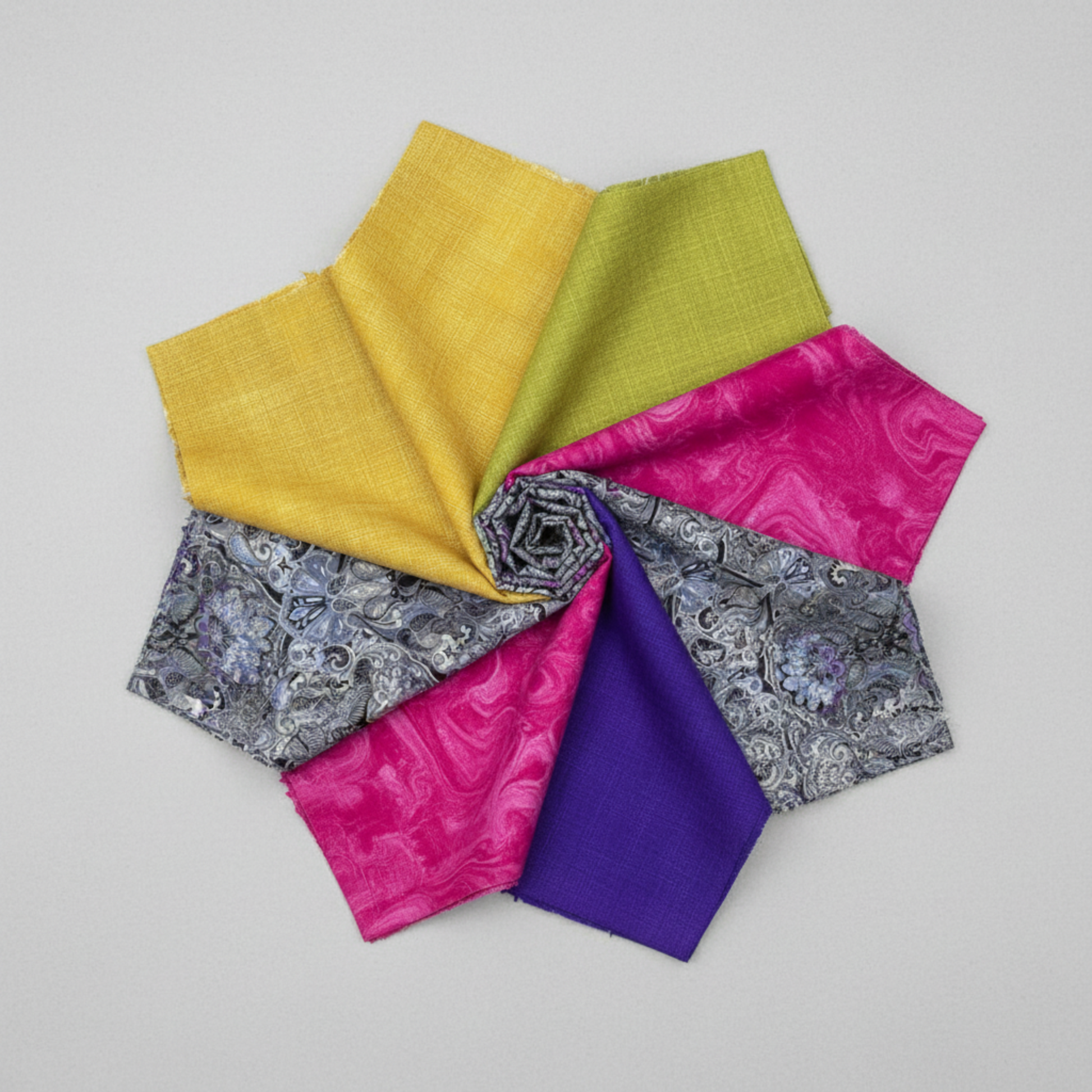 Interwoven Dark Purple quilting cotton by Jason Yenter for In The Beginning Fabrics — shown in a pinwheel fabric arrangement with coordinating Interwoven colorways in gold, chartreuse, hot pink, and grey paisley. Coordinating fabrics and quilt patterns available at IraRobi Quilts.