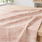 Vertical Pinterest photo of draped Celestial Stamps Text Rose Quartz fabric by Zen Chic for Moda Fabrics, featuring dusty-rose timetable text on pale blush.