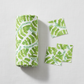 Safari Fun Jungle Leaves White quilting cotton by Terry Runyan for Benartex — folded fabric bolt showing watercolor tropical banana leaves and fern sprigs in fresh greens on crisp white, 100% cotton. Quilt blocks shown for inspiration. Coordinating fabrics and quilt patterns are available at IraRobi Quilts.