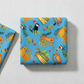 Safari Fun Playful Safari Blue/Multi quilting cotton by Terry Runyan for Benartex — folded fabric bolt showing whimsical illustrated tigers, leopards, monkeys, toucans, and parrots on bright sky blue, large-scale novelty print, 100% cotton, 43–44" wide. Quilt blocks shown for inspiration. Coordinating fabrics and quilt patterns are available at IraRobi Quilts.