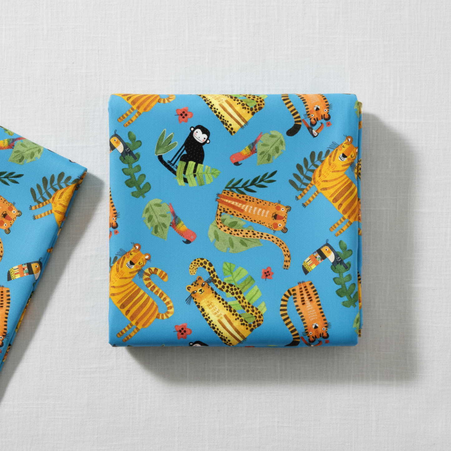 Safari Fun Playful Safari Blue/Multi quilting cotton by Terry Runyan for Benartex — folded fabric bolt showing whimsical illustrated tigers, leopards, monkeys, toucans, and parrots on bright sky blue, large-scale novelty print, 100% cotton, 43–44" wide. Quilt blocks shown for inspiration. Coordinating fabrics and quilt patterns are available at IraRobi Quilts.