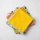 Safari Fun Random Dots Yellow/Orange by Terry Runyan for Benartex shown in a coordinating fabric stack with prints in sky blue jungle animals, orange triangles, coral sorbet, lime green, and white/black triangles. Quilt blocks shown for inspiration. Coordinating fabrics and quilt patterns are available at IraRobi Quilts.