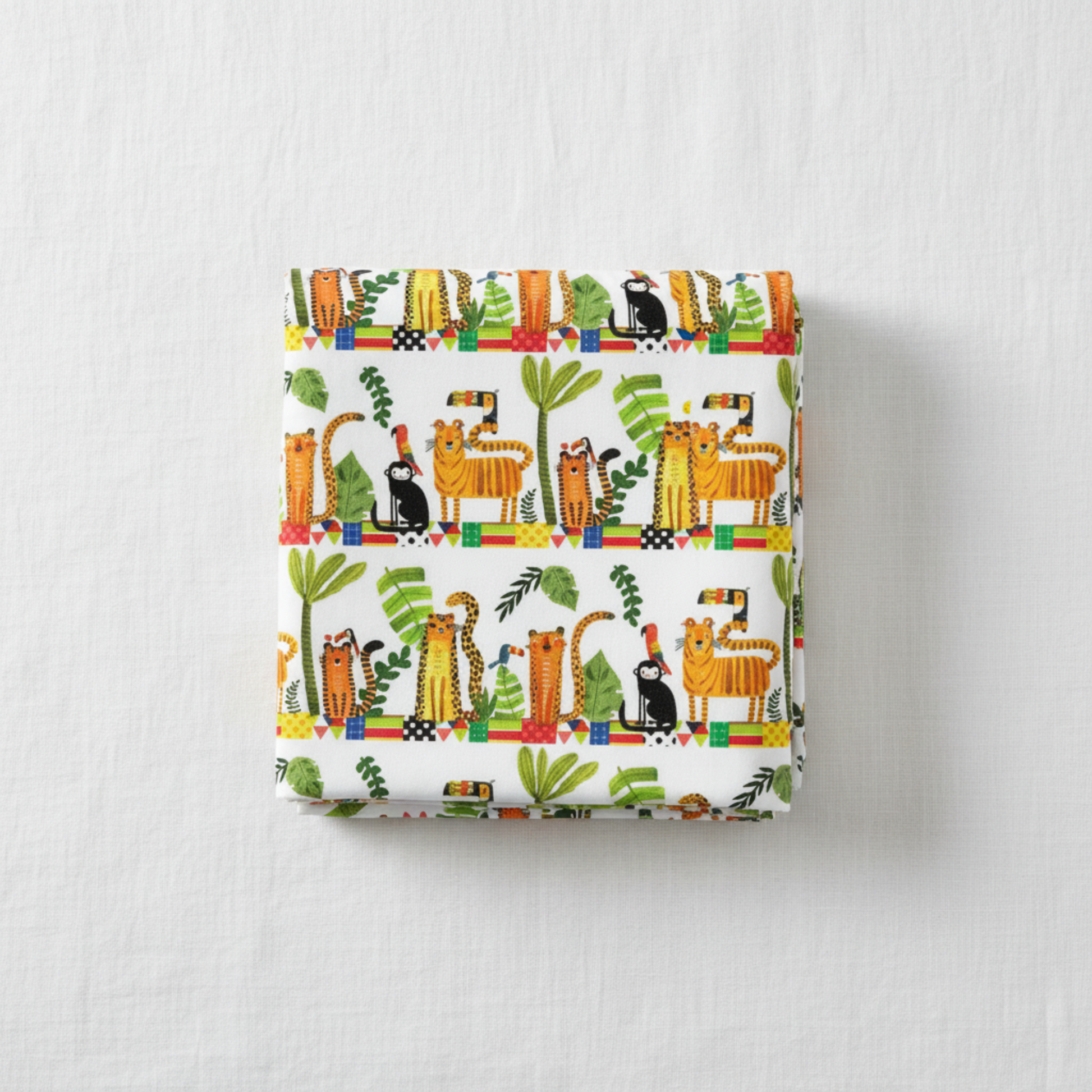 Safari Fun Stripe White/Multi quilting cotton by Terry Runyan for Benartex — folded fabric bolt showing horizontal rows of illustrated tigers, leopards, black monkeys, toucans, and parrots standing on colorful geometric blocks with palm trees and tropical leaves on white, stripe runs parallel to selvage, 100% cotton, 43–44" wide. Quilt blocks shown for inspiration. Coordinating fabrics and quilt patterns are available at IraRobi Quilts.