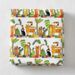 Safari Fun Stripe White/Multi quilting cotton by Terry Runyan for Benartex — folded fabric bolt showing horizontal rows of illustrated tigers, leopards, black monkeys, toucans, and parrots standing on colorful geometric blocks with palm trees and tropical leaves on white, stripe runs parallel to selvage, 100% cotton, 43–44" wide. Quilt blocks shown for inspiration. Coordinating fabrics and quilt patterns are available at IraRobi Quilts.