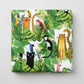 Safari Fun White/Multi quilting cotton by Terry Runyan for Benartex — folded fabric bolt showing large-scale watercolor jungle scene with leopards, black panthers, monkeys, rainbow parrots, toucans, and tigers in lush tropical foliage on crisp white, 100% cotton, 43–44" wide. Quilt blocks shown for inspiration. Coordinating fabrics and quilt patterns are available at IraRobi Quilts.