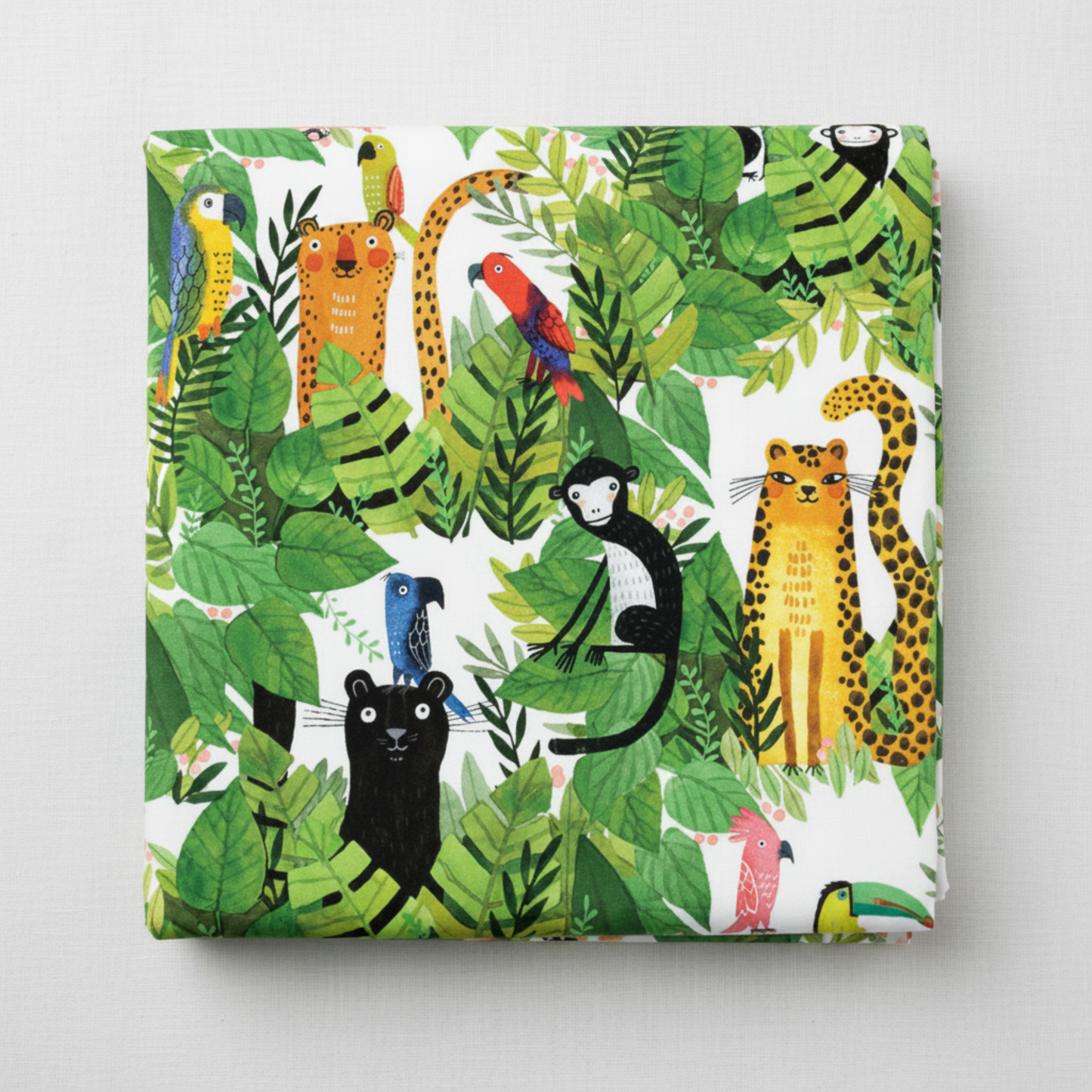 Safari Fun White/Multi quilting cotton by Terry Runyan for Benartex — folded fabric bolt showing large-scale watercolor jungle scene with leopards, black panthers, monkeys, rainbow parrots, toucans, and tigers in lush tropical foliage on crisp white, 100% cotton, 43–44" wide. Quilt blocks shown for inspiration. Coordinating fabrics and quilt patterns are available at IraRobi Quilts.