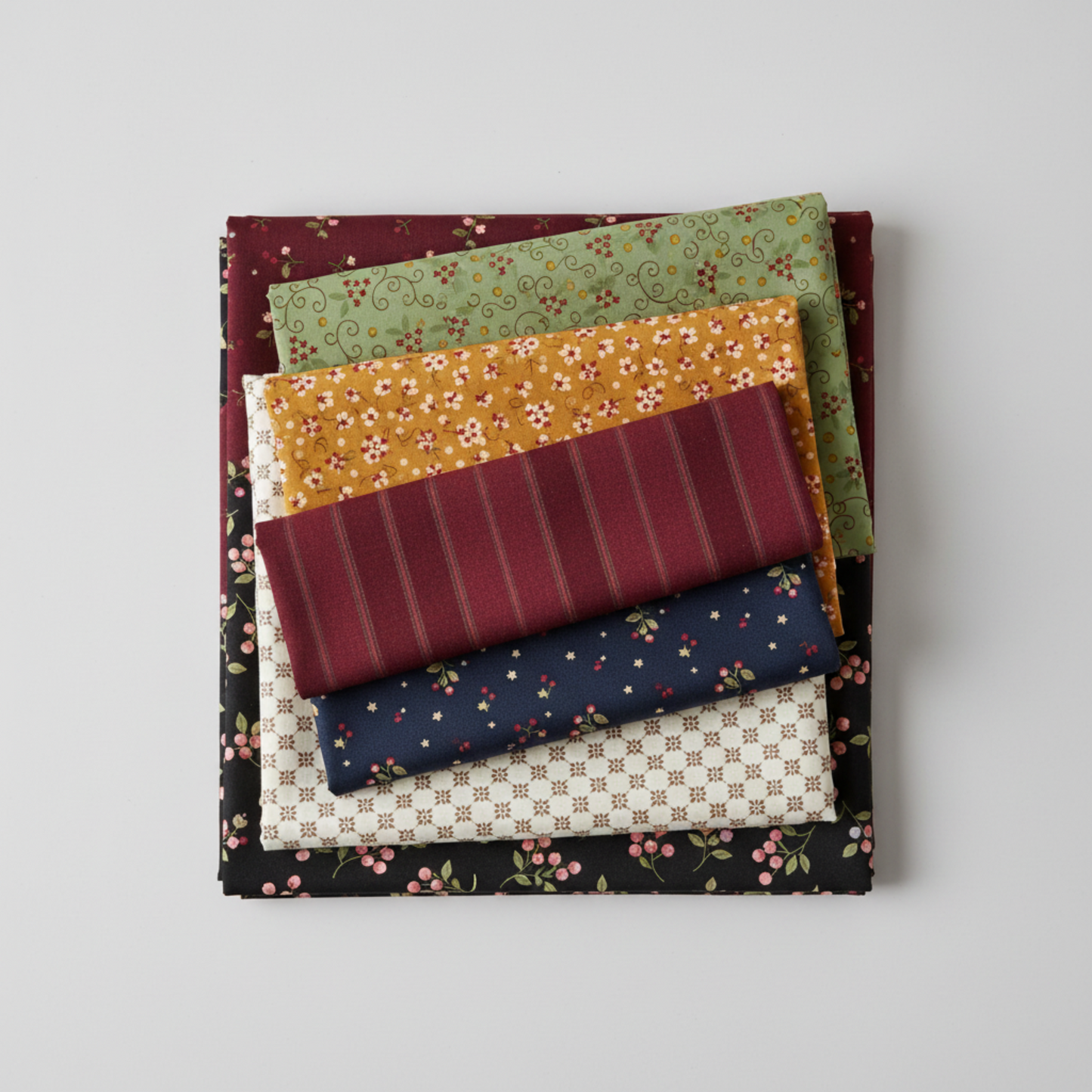 Scraps of Kindness collection coordinating fabric stack — aqua vine print with mustard, burgundy, navy, cream, and black quilting cottons