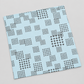 Angled swatch of Lazy Afternoon Sky Fabric by Zen Chic for Moda Fabrics on a light gray background, showing scattered grids of black cross-shaped marks.