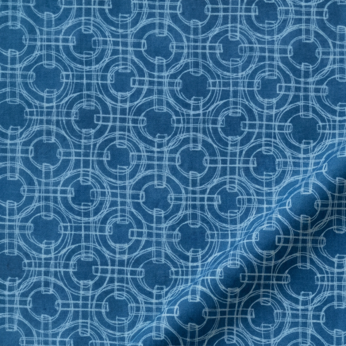 Close-up of Serena Shores Coastal fabric by Robin Pickens for Moda Fabrics, showing pale blue sketched rings and intersecting lines across deep blue cotton with a soft diagonal fold.
