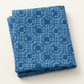 Folded Serena Shores Coastal fabric by Robin Pickens for Moda Fabrics, featuring pale blue linked rings and intersecting lines on deep blue cotton.