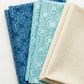 Folded Serena Shores Coastal and Mist fabrics by Robin Pickens for Moda Fabrics, with deep blue and pale aqua linked-ring prints alongside a coordinating cream textured fabric.