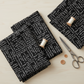 Writing on the Wall Curves Black quilting cotton folded stack with thread spool and scissors – Sew Kind of Wonderful for FreeSpirit Fabrics