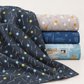 Bluish Pins & Buttons Charcoal fabric draped beside coordinating gray, navy, and pale blue modern quilting fabrics.