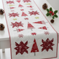 Winter Solstice II Red Snowflakes Metallic quilting cotton by Jason Yenter for In The Beginning Fabrics — shown in a finished quilted Christmas table runner featuring tree and star blocks on a white dotted background with red and white binding, styled with pine cones and holly. Quilts shown for inspiration. Coordinating fabrics and quilt patterns are available at IraRobi Quilts.