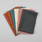 Spotted Charcoal quilting cotton fabric shown in a coordinating fabric stack – deep charcoal-grey tonal speckled near-solid blender by Zen Chic for Moda Fabrics, 100% cotton