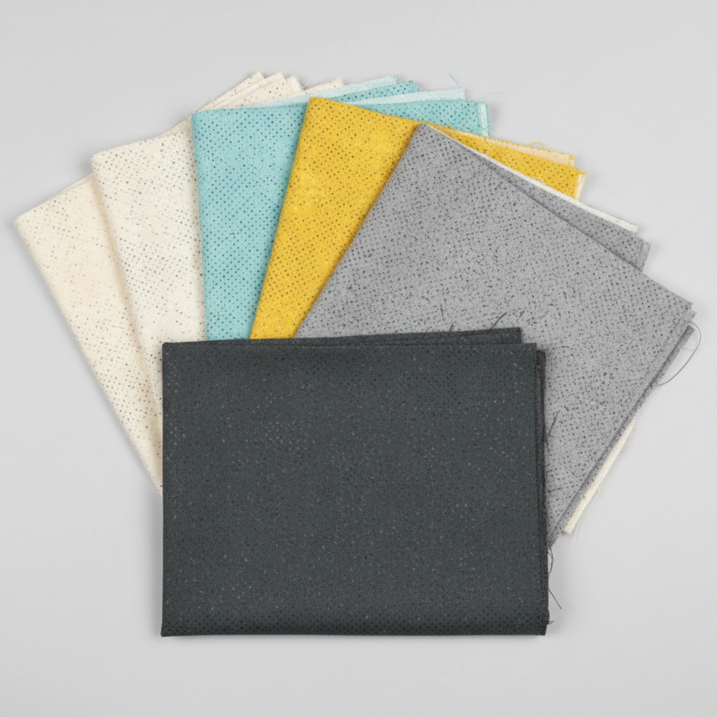 Spotted Charcoal quilting cotton fabric stacked with coordinating fabrics – deep charcoal-grey tonal speckled near-solid blender by Zen Chic for Moda Fabrics, 100% cotton