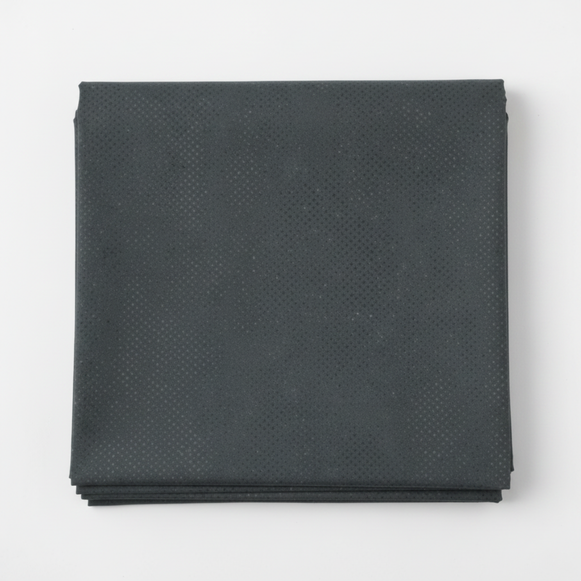 Spotted Charcoal quilting cotton fabric folded to show texture – deep charcoal-grey tonal speckled near-solid blender by Zen Chic for Moda Fabrics, 100% cotton