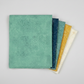 Spotted Chill-Aqua fabric by Zen Chic for Moda Fabrics shown in a coordinating fabric fan with Spotted Mood Dark Blue, Spotted Dusty Teal, Spotted Sunny, and Spotted Ivory — all available at IraRobi Quilts.